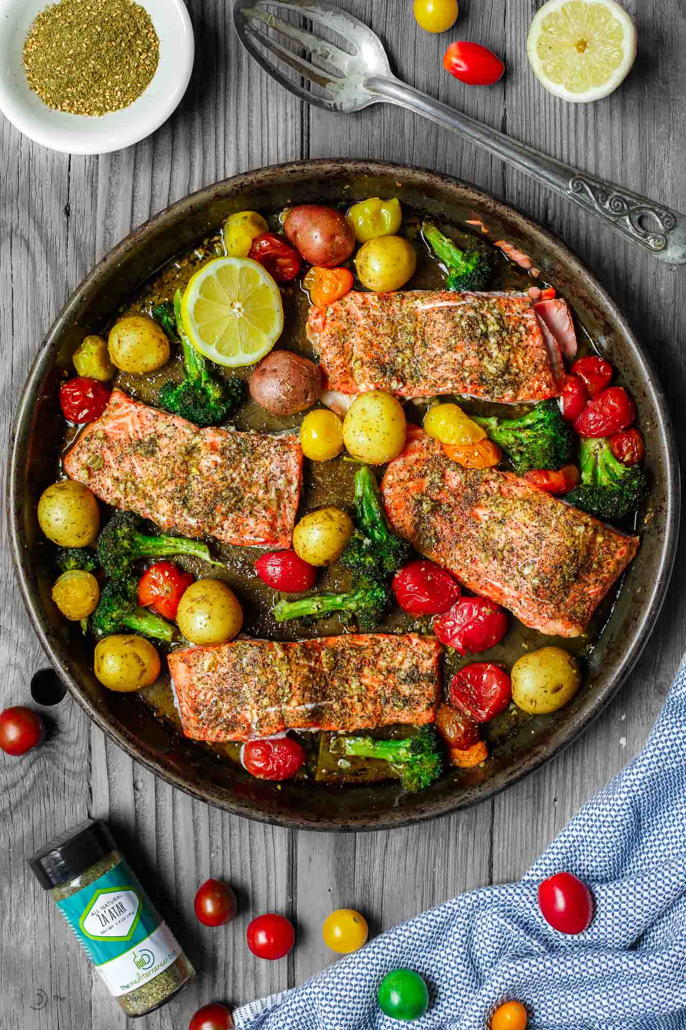 Finished dish - colorful and tasty garlic za'atar salmon with potatoes, broccoli and grape tomatoes.