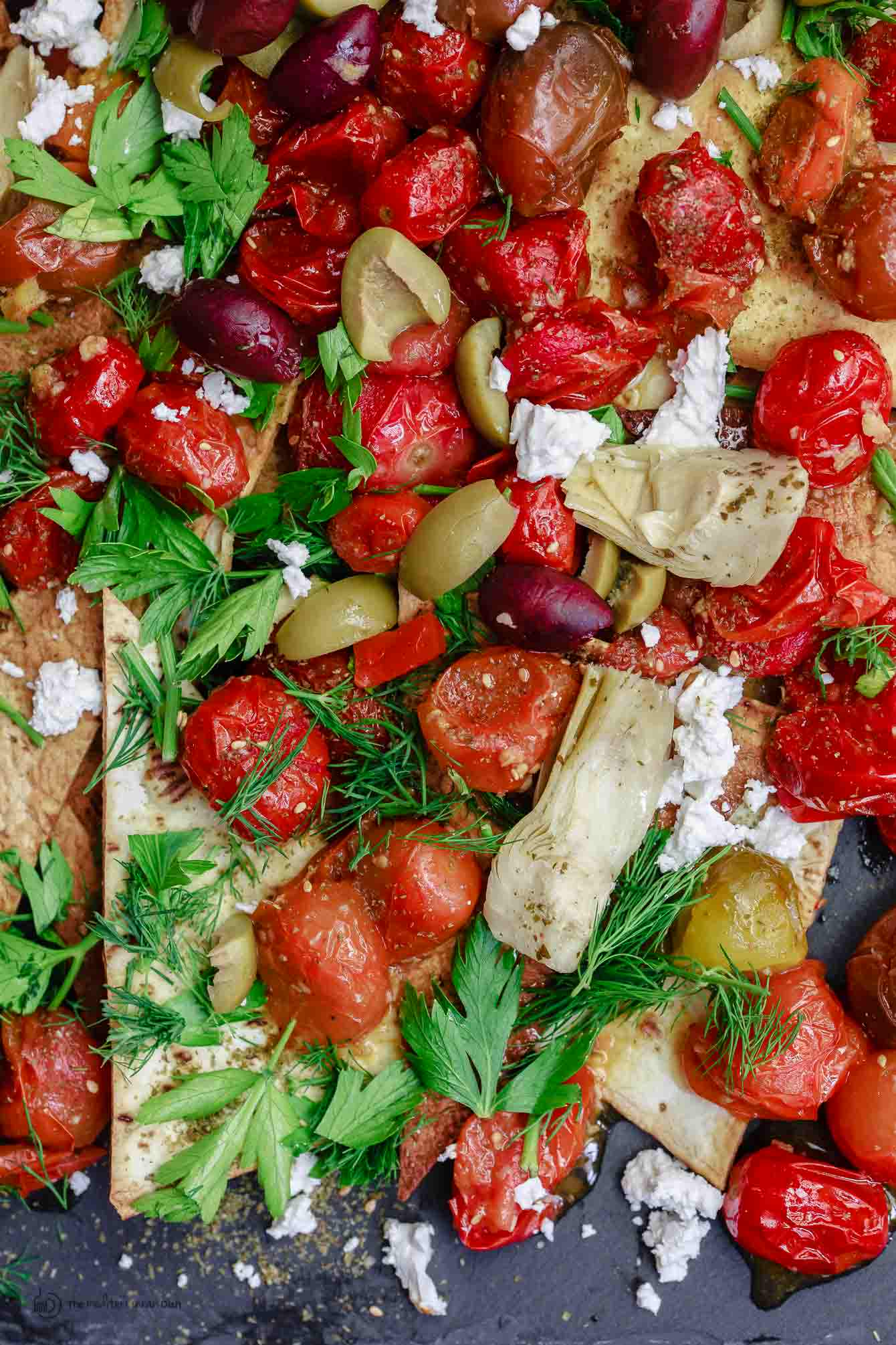 Close-up of vegetables on top of flatbread nachos