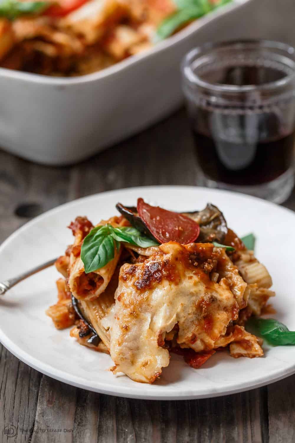 One serving of baked rigatoni with garnish of basil