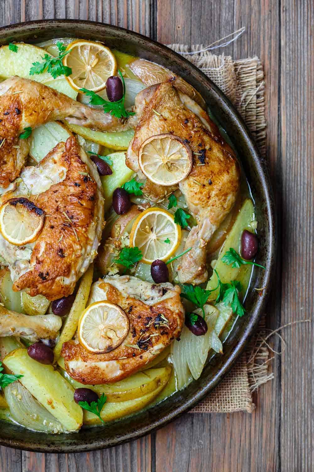 Easy Greek Chicken and Potato Dinner | The Mediterranean Dish. BEST Greek chicken and potato dinner all in one sheet pan! Seasoned with rosemary and baked in a zesty juice with lots of garlic. Definite Winner!