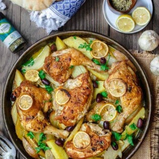 Easy Greek Chicken and Potato Dinner | The Mediterranean Dish. BEST Greek chicken and potato dinner all in one sheet pan! Seasoned with rosemary and baked in a zesty juice with lots of garlic. Definite Winner!