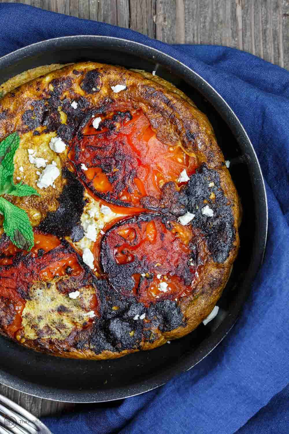 Skillet containing Open-Faced Greek Omelet