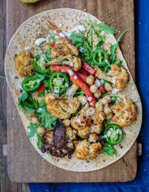 Mediterranean Vegan Wraps with Cauliflower and Tahini | The Mediterranean Dish. Satisfying vegan wraps with a Mediterranean twist. With za'atar roasted cauliflower, homemade tahini sauce, and a peppery arugula salad. A flavor-packed meatless dinner! See the recipe on TheMediterraneanDish.com