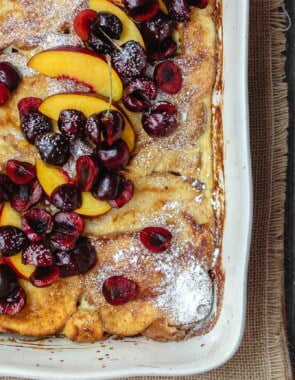 Overnight Baked French Toast Recipe with Challah | The Mediterranean Dish. Stupid easy and healtiher overnight french toast! Challah french toast with a reduced-fat yogurt custard, topped with fresh fruit and honey simple syrup. Prep it overnight and come morning, simply slip into the oven and enjoy your coffee!