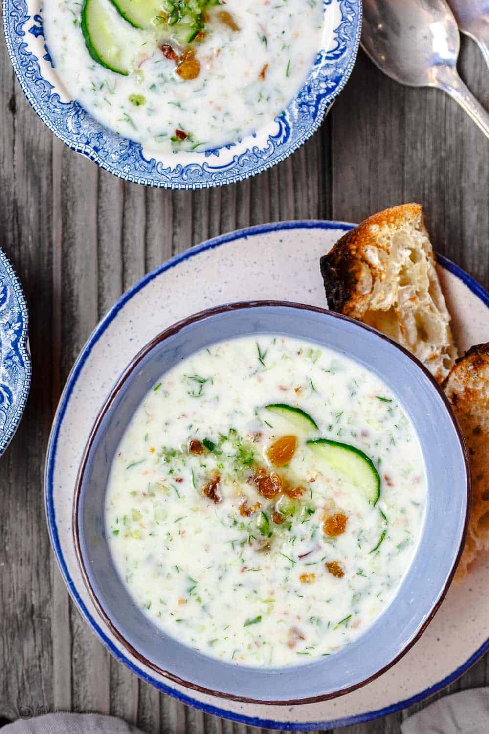 Persian-Style Chilled Cucumber Soup, topped with walnuts, raisins and sliced cucumbers