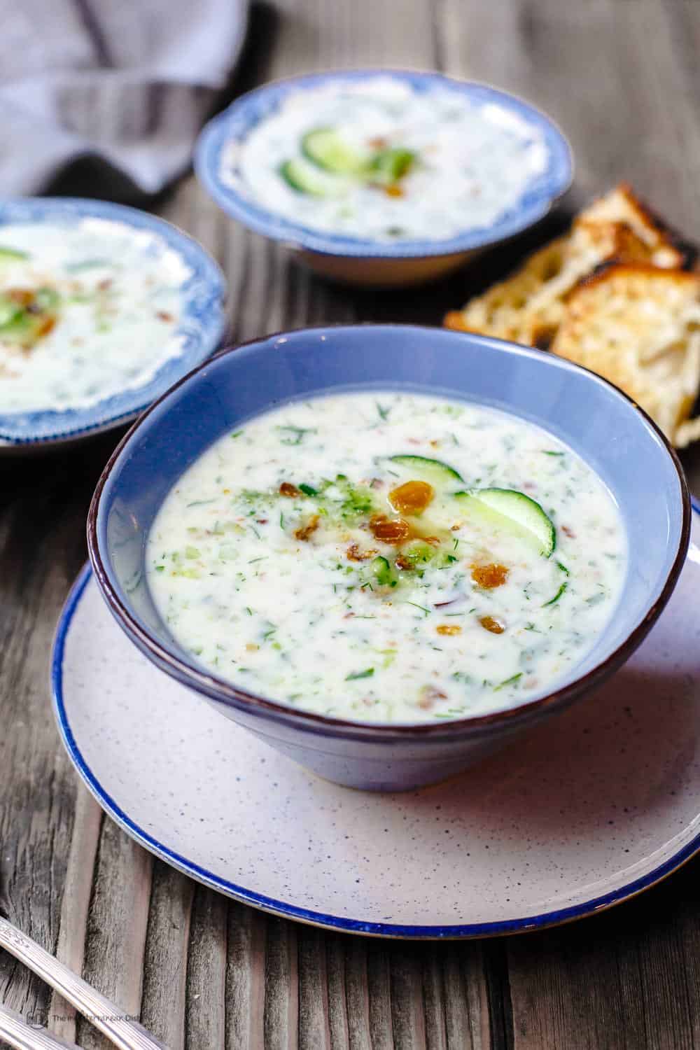 Three servings of Cucumber Soup garnished with cucumber slices