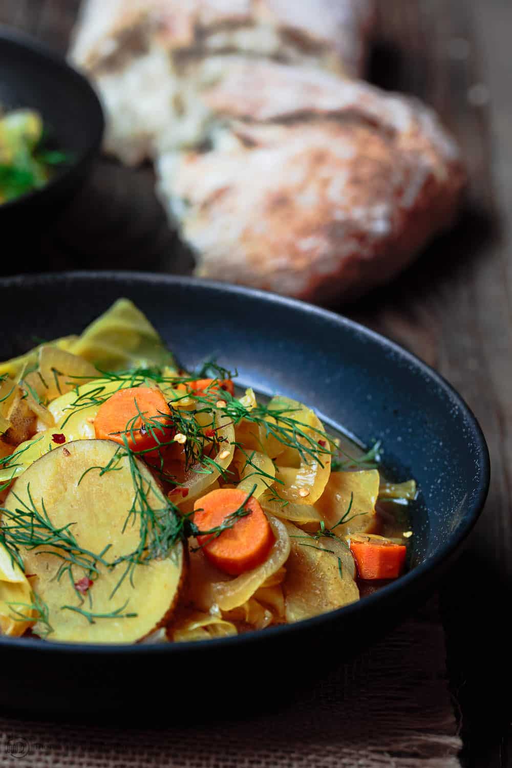 Mediterranean Slow Cooker Cabbage Soup | The Mediterranean Dish. Gluten free and vegan cabbage soup with a Mediterranean twist. Hearty, rustic, satisfying and filled with flavor from Mediterranean spices and fresh herbs. See the easy recipe on TheMediterraneanDish.com #slowcooker #soup #cabbagesoup #vegancabbagesoup #mediterraneandiet