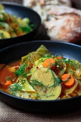 Mediterranean Slow Cooker Cabbage Soup | The Mediterranean Dish. Gluten free and vegan cabbage soup with a Mediterranean twist. Hearty, rustic, satisfying and filled with flavor from Mediterranean spices and fresh herbs. See the easy recipe on TheMediterraneanDish.com #slowcooker #soup #cabbagesoup #vegancabbagesoup #mediterraneandiet