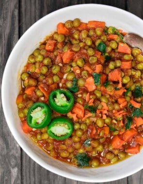 Egyptian Vegan Stew with Peas and Carrots | The Mediterranean Dish! A hearty vegan stew with peas and carrots in a tasty aromatic tomato sauce. Great weeknight meal. Comes together in less than 30 minutes! See it on The Mediterranean Dish.com