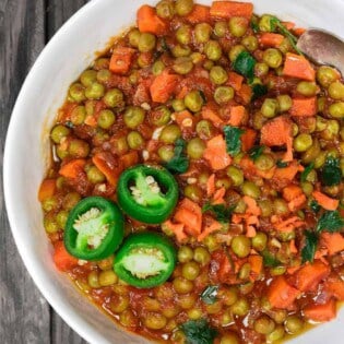 Egyptian Vegan Stew with Peas and Carrots | The Mediterranean Dish! A hearty vegan stew with peas and carrots in a tasty aromatic tomato sauce. Great weeknight meal. Comes together in less than 30 minutes! See it on The Mediterranean Dish.com