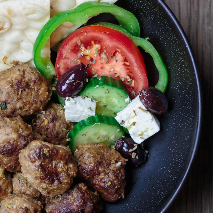 Keftedes Greek Meatballs Recipe | The Mediterranean Dish. Best Greek meatballs ever! Spiced with fresh mint, oregano and more, pan-fried in olive oil then finished with a thick lemony sauce. Serve it with pita and Greek salad and you've got an amazing Greek dinner! See the easy recipe on TheMediterraneanDish.com #greekmeatballs #meatballs #meatballrecipe #greekfood #greekrecipe