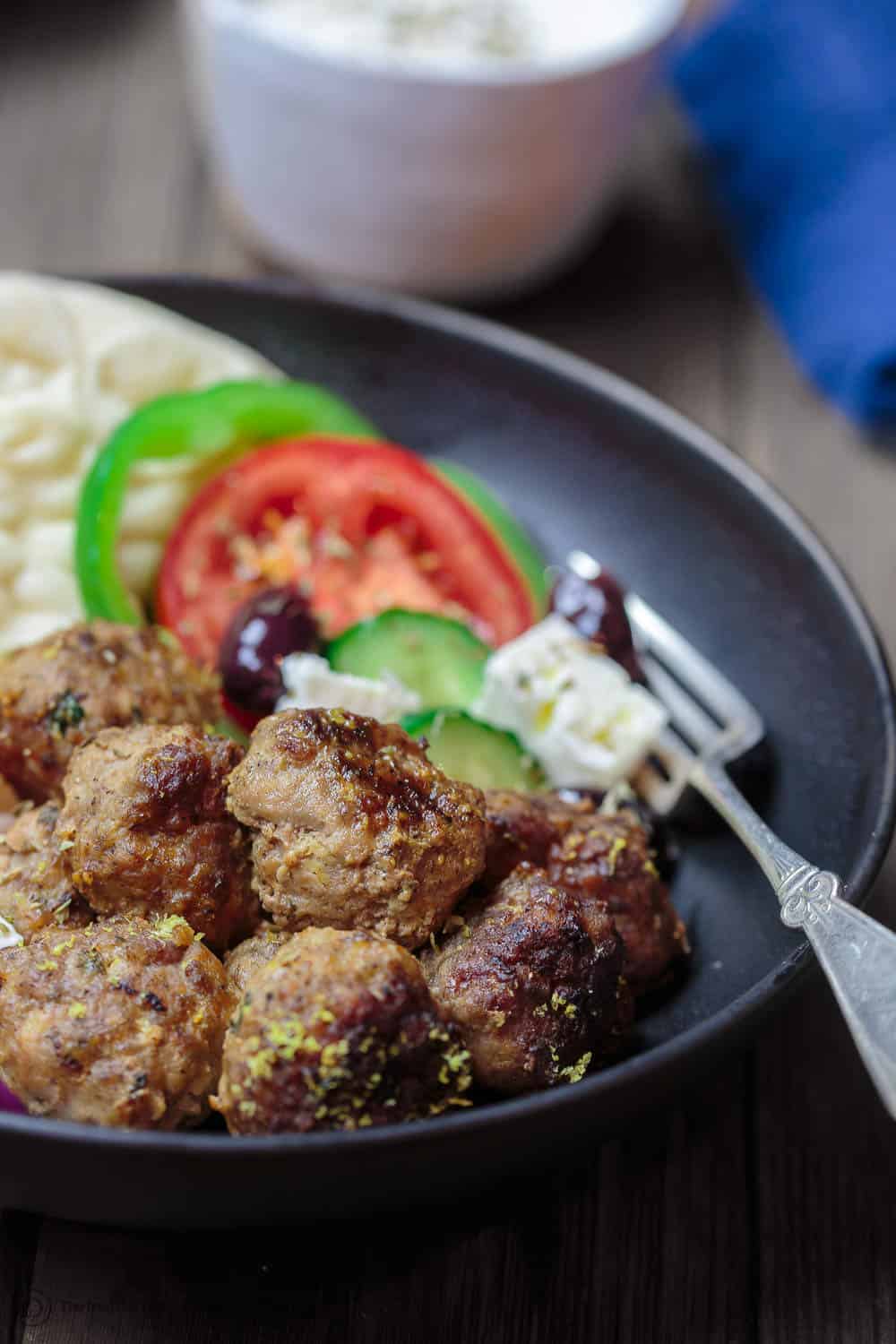Keftedes Greek Meatballs Recipe | The Mediterranean Dish. Best Greek meatballs ever! Spiced with fresh mint, oregano and more, pan-fried in olive oil then finished with a thick lemony sauce. Serve it with pita and Greek salad and you've got an amazing Greek dinner! See the easy recipe on TheMediterraneanDish.com #greekmeatballs #meatballs #meatballrecipe #greekfood #greekrecipe 