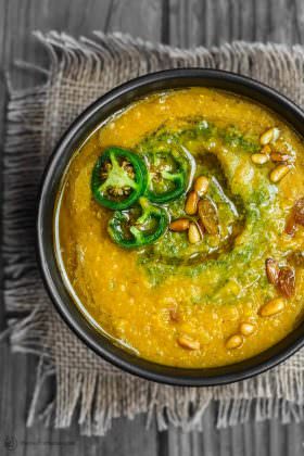 Easy Lentil Pumpkin Soup Recipe | The Mediterranean Dish. A quick and satisfying pumpkin soup with red lentils and earthy, bold Middle Eastern flavors! A hint of cumin and turmeric change everything here, plus an added spoonful of spicy cilantro pesto (optional, but so good). See the full recipe on TheMediterraneanDish.com