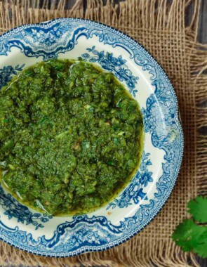 Zhoug: Spicy Cilantro Pesto | The Mediterranean Dish. A fragrant, spicy green sauce with fresh cilantro, parsley, Middle Eastern spices and olive oil. Think cilantro pesto with a nice kick. Great on all sorts of sandwiches, stirred into soup, or as a topping to your meat! See the recipe on TheMediterraneanDish.com