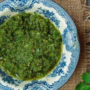 Zhoug: Spicy Cilantro Pesto | The Mediterranean Dish. A fragrant, spicy green sauce with fresh cilantro, parsley, Middle Eastern spices and olive oil. Think cilantro pesto with a nice kick. Great on all sorts of sandwiches, stirred into soup, or as a topping to your meat! See the recipe on TheMediterraneanDish.com