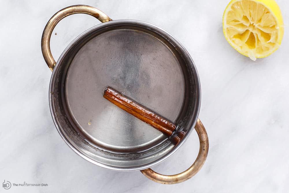 Cinnamon stick boiled in a pot with sugar and water