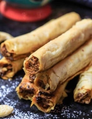 Cashew Filled Baklava Rolls | The Mediterranean Dish. A unique and simple Baklava recipe perfect for entertaining. Perfectly crispy phyllo rolls filled with a tasty cashew mixture and drenched in a lemon simple syrup. See the easy step-by-step tutorial and recipe on TheMediterraneanDish.com #baklava #dessert #pastry #phyllo #baklavarecipe #phyllorecipe #fillo #greekrecipe #turkishrecipe #holidaydessert #fingerfood #partyfood #thanksgiving #christmasdessert #christmas #christmasdinner #christmasbrunch