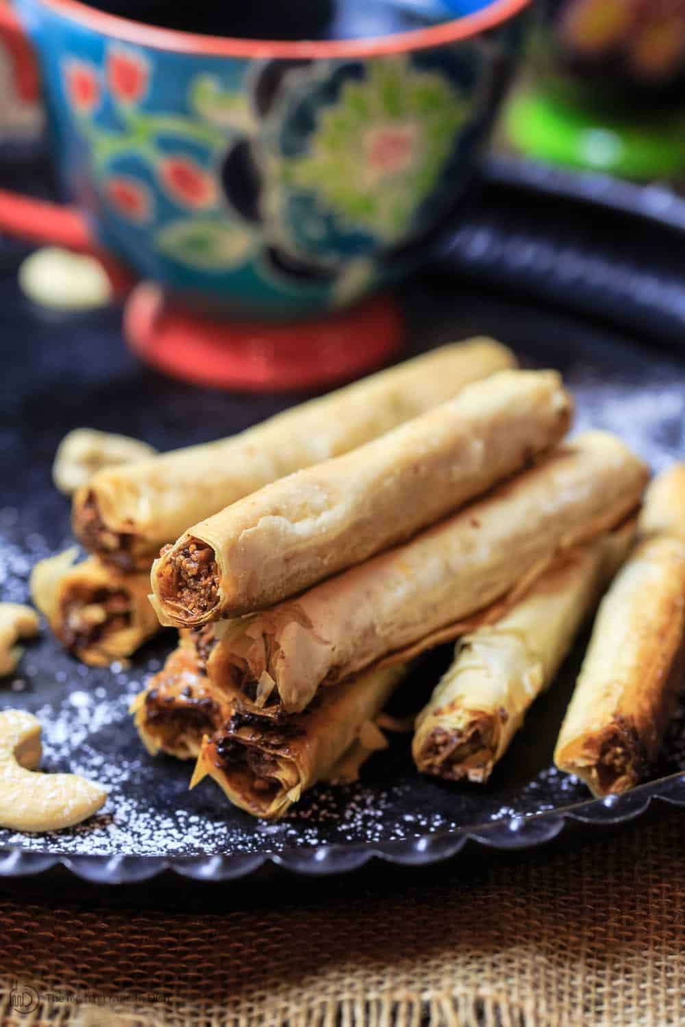 Baklava Rolls served on a plate with cashews on the side