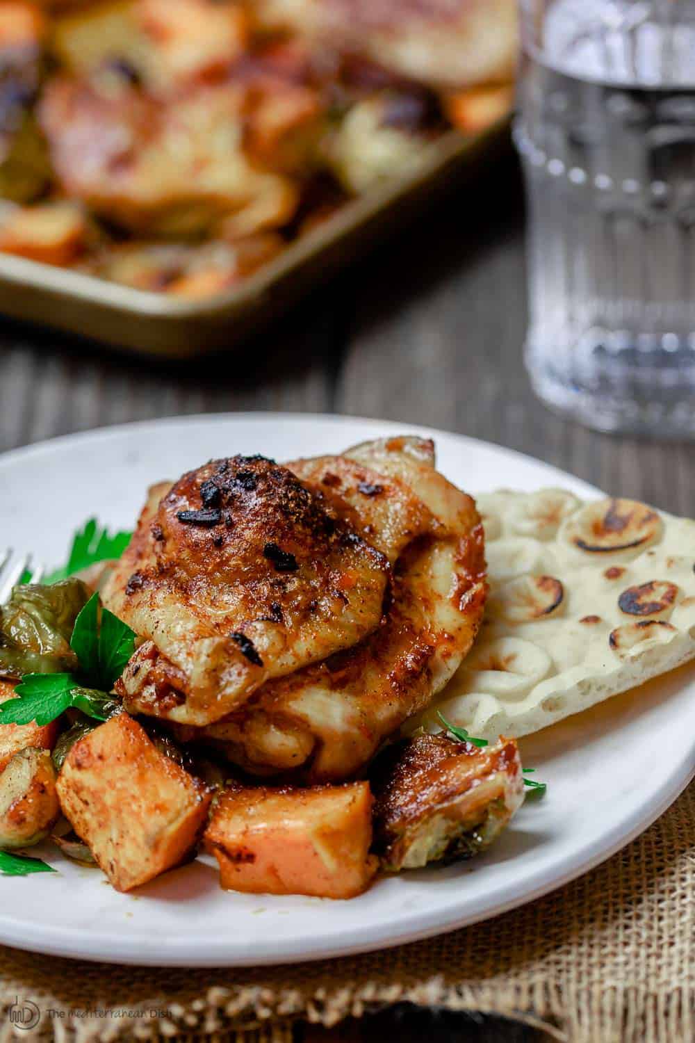 Close-up of chicken and vegetables served with pita bread