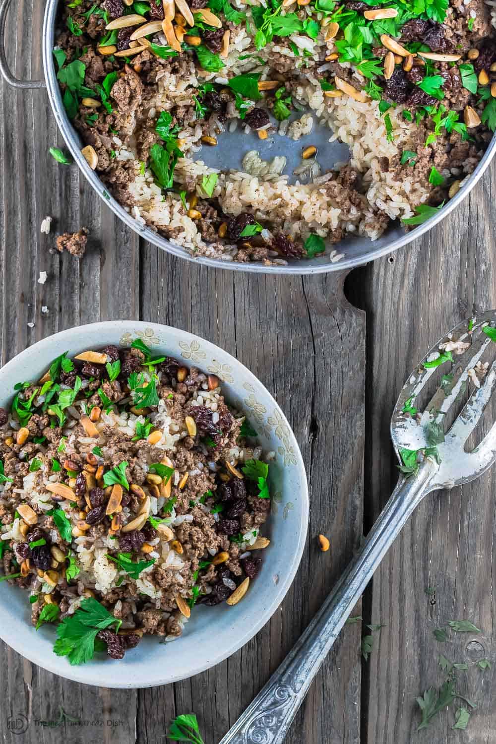 Lebanese Rice (Hashweh) | The Mediterranean Dish. Easy, flavorful loaded Lebanese Rice with ground beef, toasted nuts, raisins and sweet, earthy spices. Makes the perfect side dish or dinner bowl. Think also gluten free stuffing! #rice #lebaneserice #middleeasternrice #lebaneserecipe #mediterraneanrecipe