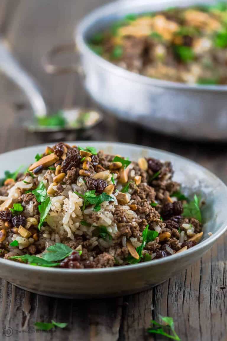 Lebanese Rice (Hashweh) | The Mediterranean Dish. Easy, flavorful loaded Lebanese Rice with ground beef, toasted nuts, raisins and sweet, earthy spices. Makes the perfect side dish or dinner bowl. Think also gluten free stuffing! #rice #lebaneserice #middleeasternrice #lebaneserecipe #mediterraneanrecipe