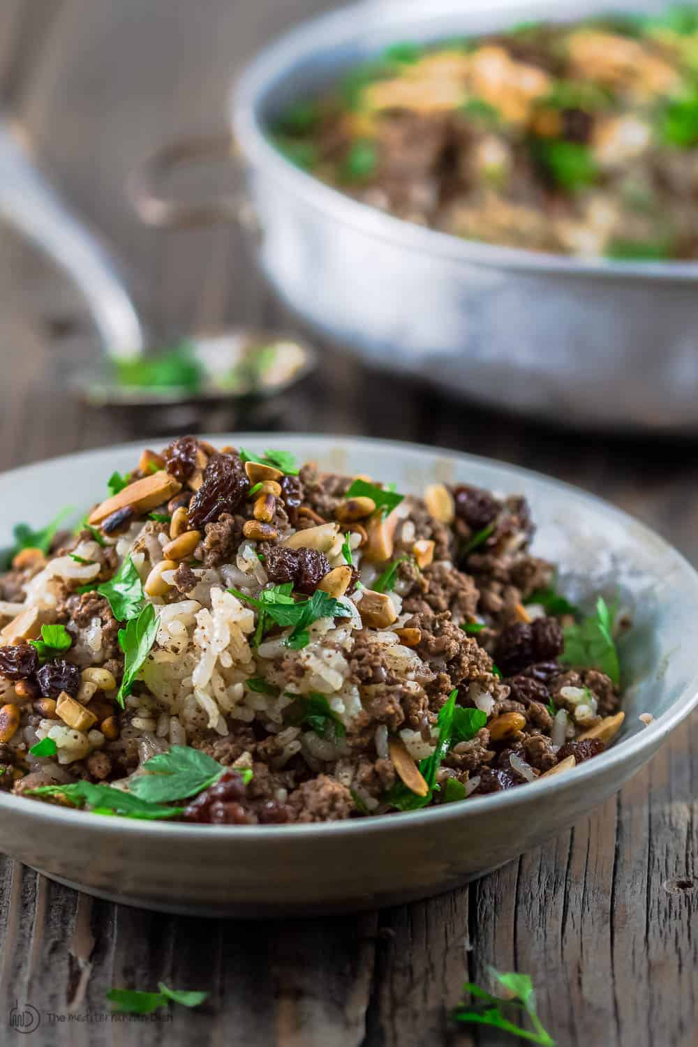 Lebanese Rice (Hashweh) | The Mediterranean Dish. Easy, flavorful loaded Lebanese Rice with ground beef, toasted nuts, raisins and sweet, earthy spices. Makes the perfect side dish or dinner bowl. Think also gluten free stuffing! #rice #lebaneserice #middleeasternrice #lebaneserecipe #mediterraneanrecipe