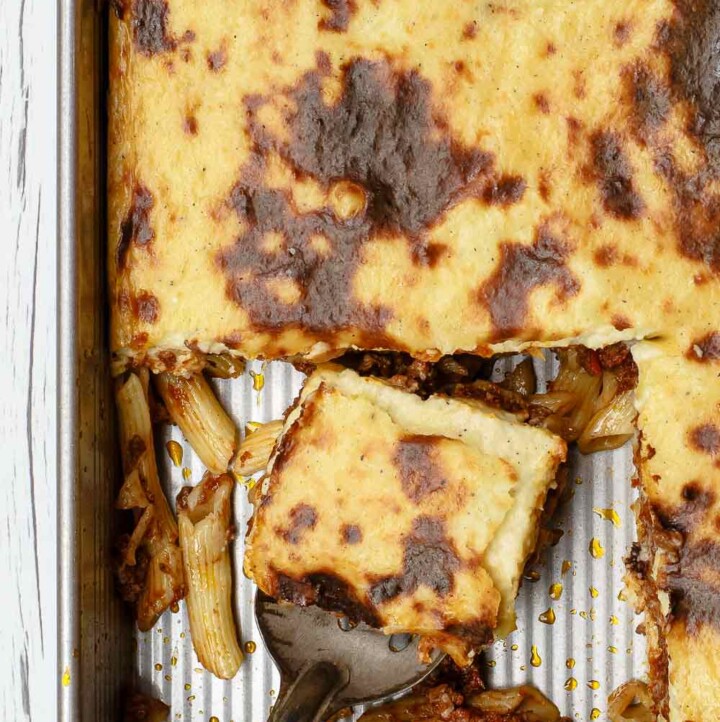 Greek Pastitsio Recipe | The Mediterranean Dish. A delectable Greek baked pasta casserole with flavor-packed meat sauce and a creamy bechamel topping. This is a lightened up pastitsio recipe that is every bit as indulgent with only 230 calories per serving. And it serves a crowd! See the full recipe on TheMediterraneanDish.com