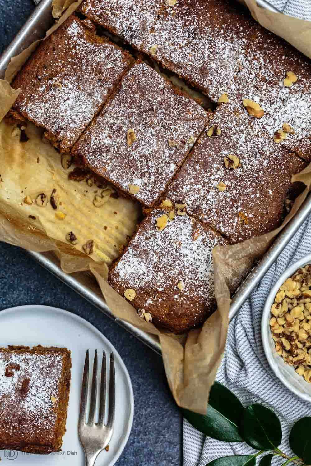 Carrot Cake garnished with walnuts cut into squares and served