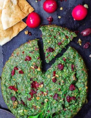 Kuku Sabzi: Persian Herb Baked Omelet | The Mediterranean Dish. Light, herby, flavor-packed Persian baked omelet or frittata with tons of fresh herbs and beautiful spices that will have you coming for more. Perfect for your next special brunch! Get the full recipe on TheMediterraneanDish.com #eggs #breakfast #christmasbrunch #bakedomelet #frittata #mediterraneanrecipe #persianrecipe #kukusabzi
