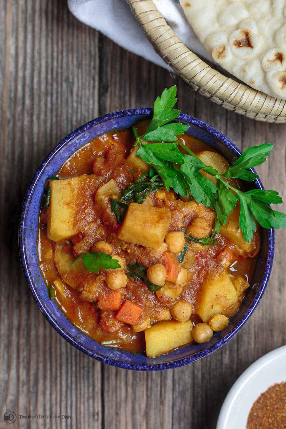 Moroccan Vegetable Tagine Recipe | The Mediterranean Dish. A simple and succulent vegetable stew, flavored Morrocan-style with warm spices, aromatics, and dried apricots. The best vegetable tagine or vegetable stew you'll have. See it on TheMediterraneanDish.com #vegetablestew #tagine #mediterraneanfood #moroccanfood #veganrecipe #onepot