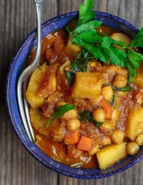 Moroccan Vegetable Tagine Recipe | The Mediterranean Dish. A simple and succulent vegetable stew, flavored Morrocan-style with warm spices, aromatics, and dried apricots. The best vegetable tagine or vegetable stew you'll have. See it on TheMediterraneanDish.com #vegetablestew #tagine #mediterraneanfood #moroccanfood #veganrecipe #onepot