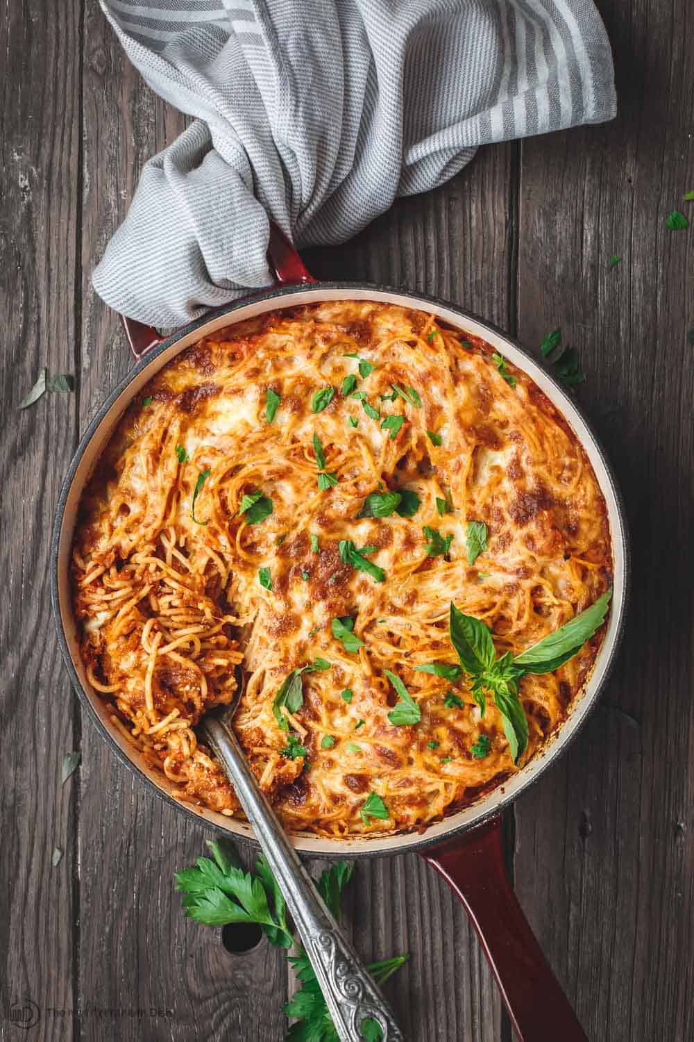 Hearty baked spaghetti in a casserole dish ready to be served.