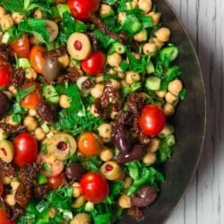 Balela Salad Recipe | The Mediterranean Dish. Bright, flavor-packed Mediterranean chickpea salad with chopped veggies, lots of herbs, and favorites like olives and sun-dried tomatoes. A zesty dressing brings it all together! A simple recipe from TheMediterraneanDish.com #balela #chickpeasalad #mediterraneanfood #mediterraneanrecipe