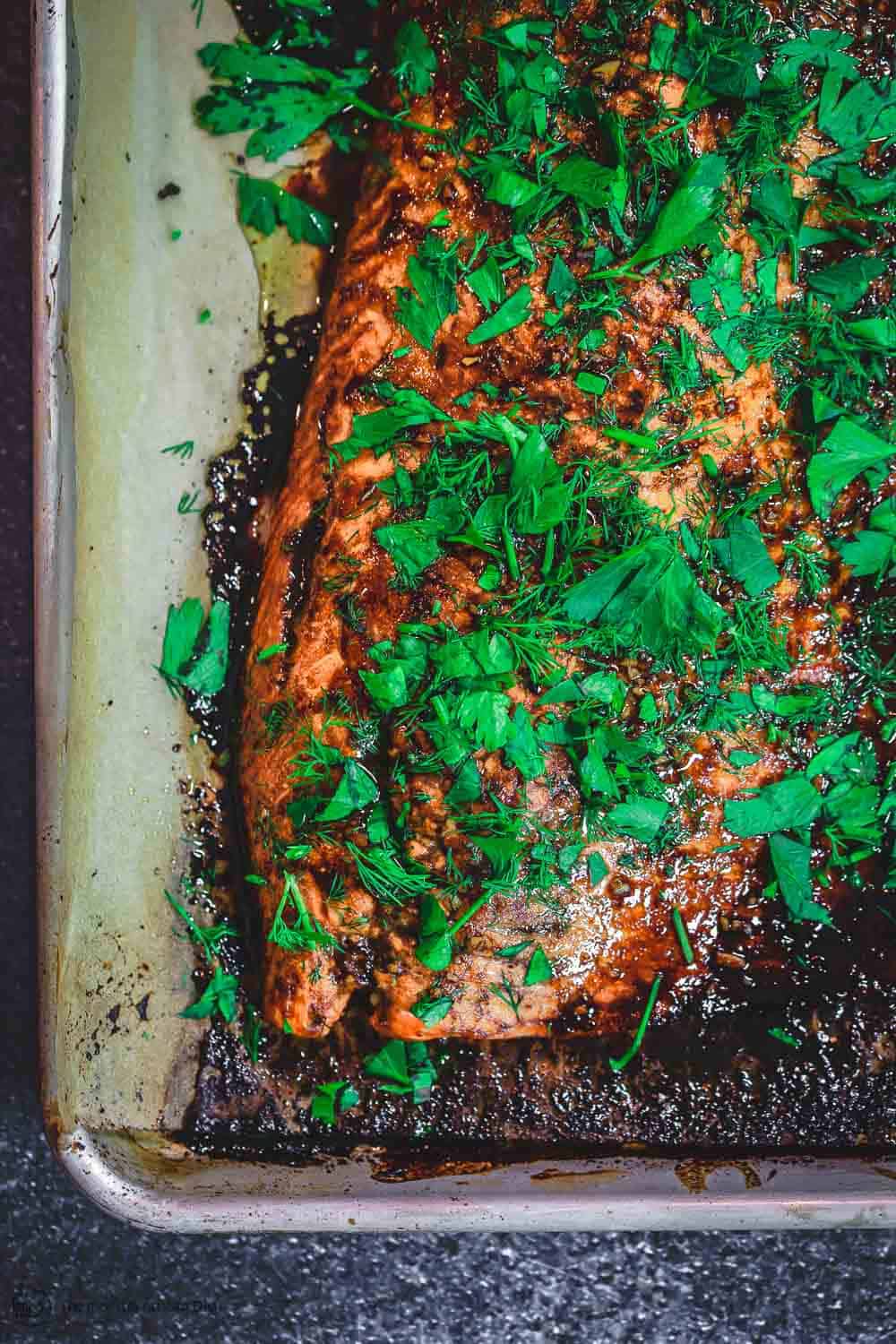 Baked Salmon garnished with fresh dill and parsley