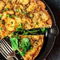 Simple Spanish Tortilla Recipe | The Mediterranean Dish. Spanish tortilla is a simple, satisfying, and perfectly layered potato and egg casserole. Serve it with our easy spinach and arugula salad. Get both recipes on TheMediterraneanDish.com #spanishtortilla #eggcasserole #fritatta #mediterraneanfood #mediterraneanrecipe #brunch #breakfast