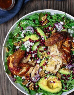 Chicken Arugula Salad with Ginger Pomegranate Dressing | The Mediterranean Dish. Loaded arugula salad with pomegranates, avocado, cucumber, and chicken. The best fresh ginger and pomegranate dressing brings so much flavor and brightness. Simple weeknight dinner! From TheMediterraneanDish.com #arugulasalad #mediterraneandiet #mediterraneanrecipes #mediterraneanfood #healthyrecipes #salad #healthydinner #lowcaloriedinner