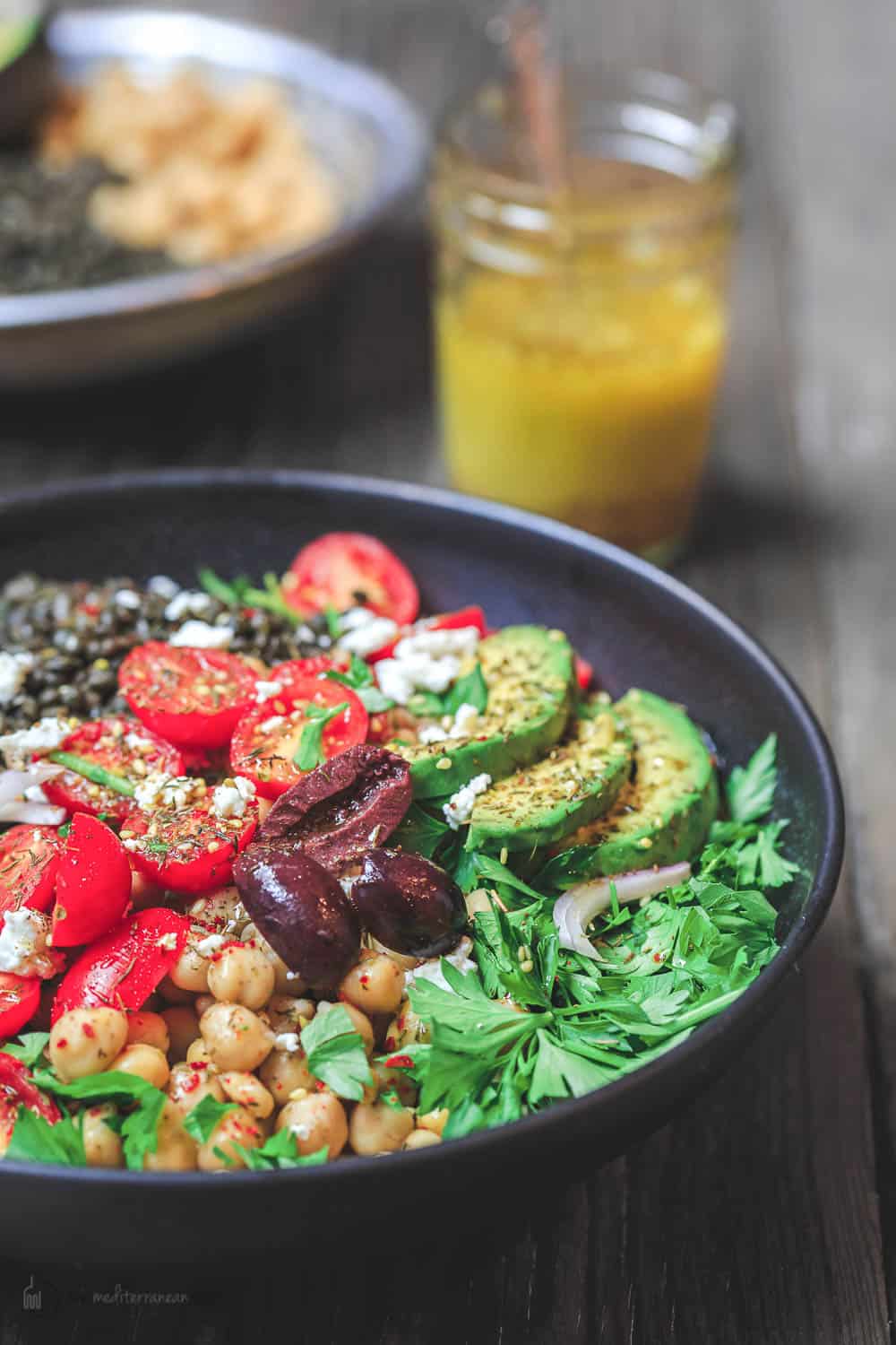 Mediterranean Grain Bowls with lentils, zucchini, avocados, tomatoes and topped with feta cheese.