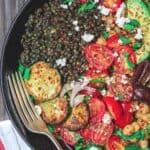 Mediterranean Grain Bowls with lentils, zucchini, avocados, tomatoes and topped with feta cheese.