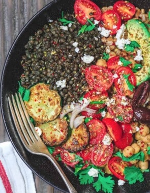 Mediterranean Grain Bowls with lentils, zucchini, avocados, tomatoes and topped with feta cheese.