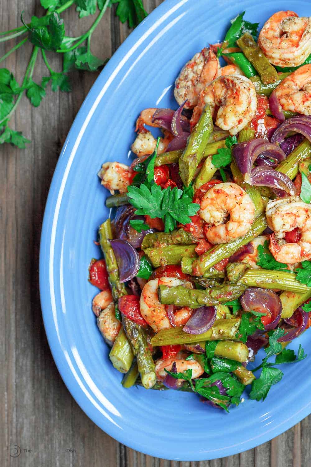 Baked shrimp with Mediterranean flavors and healthy veggies served on a dish