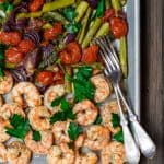 Mediterranean Sheet Pan Shrimp and Veggies | The Mediterranean Dish. Easy, quick baked shrimp with veggies, all dressed in a Mediterranean citrus-ginger sauce. Ready in 25 minutes! From TheMediterraneanDish.com #shrimp #mediterranean #mediterraneandiet #easyrecipe #onepanmeal #sheetpandinner #seafood #healthyrecipes #whole30 #glutenfree