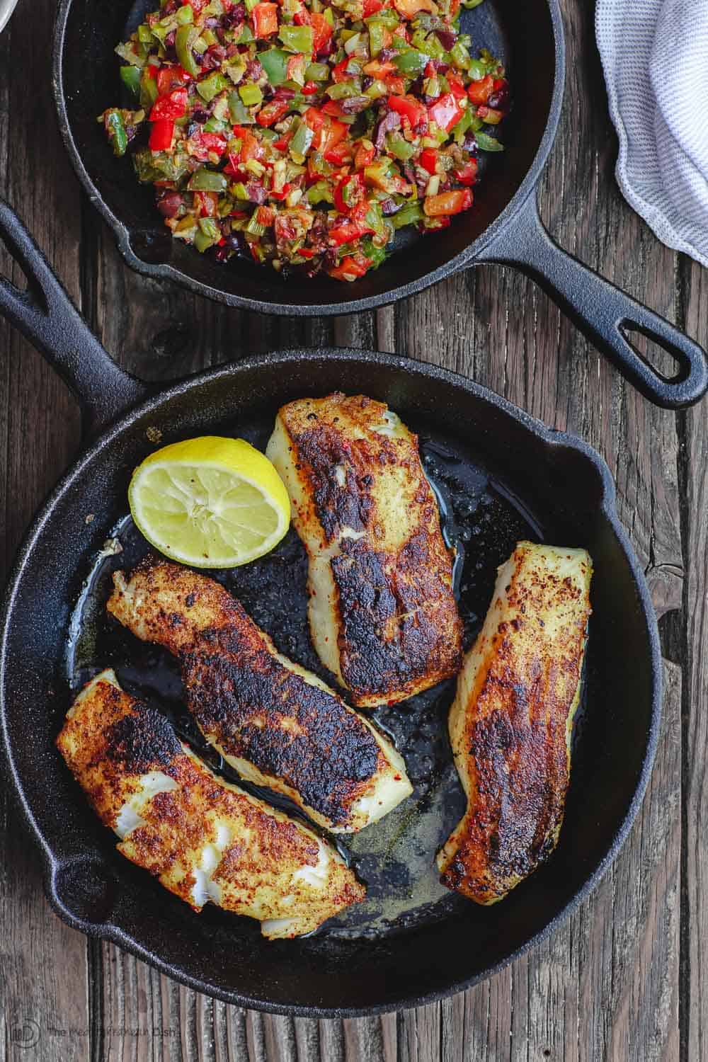 Pan seared sea bass in a skillet