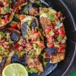 Mediterranean Pan Seared Sea Bass Recipe | The Mediterranean Dish. Quick and crispy pan seared sea bass, coated with Mediterranean spices and a tasty bell pepper medley to serve on top or as a side! Dinner in minutes! from TheMediterraneanDish.com #mediterraneandiet #mediterraneanrecipes #seafoodrecipes #fish #fishrecipes #healthyrecipes #lowcarbrecipes #weeknightdinner #weeknightmeal #onpotdinner #onepan #glutenfreerecipes #seabass #easyrecipes
