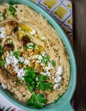 Roasted Garlic Hummus | The Mediterranean Dish. Smooth and creamy hummus dip with the perfect flavor combination. Sweet. Smoky. And just enough zing. Top it with toasted pine nuts, and feta. The best roasted garlic hummus ever from TheMediterraneanDish.com