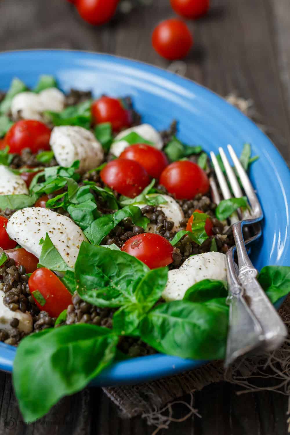 Caprese Lentil Salad garnished with fresh basil leaves