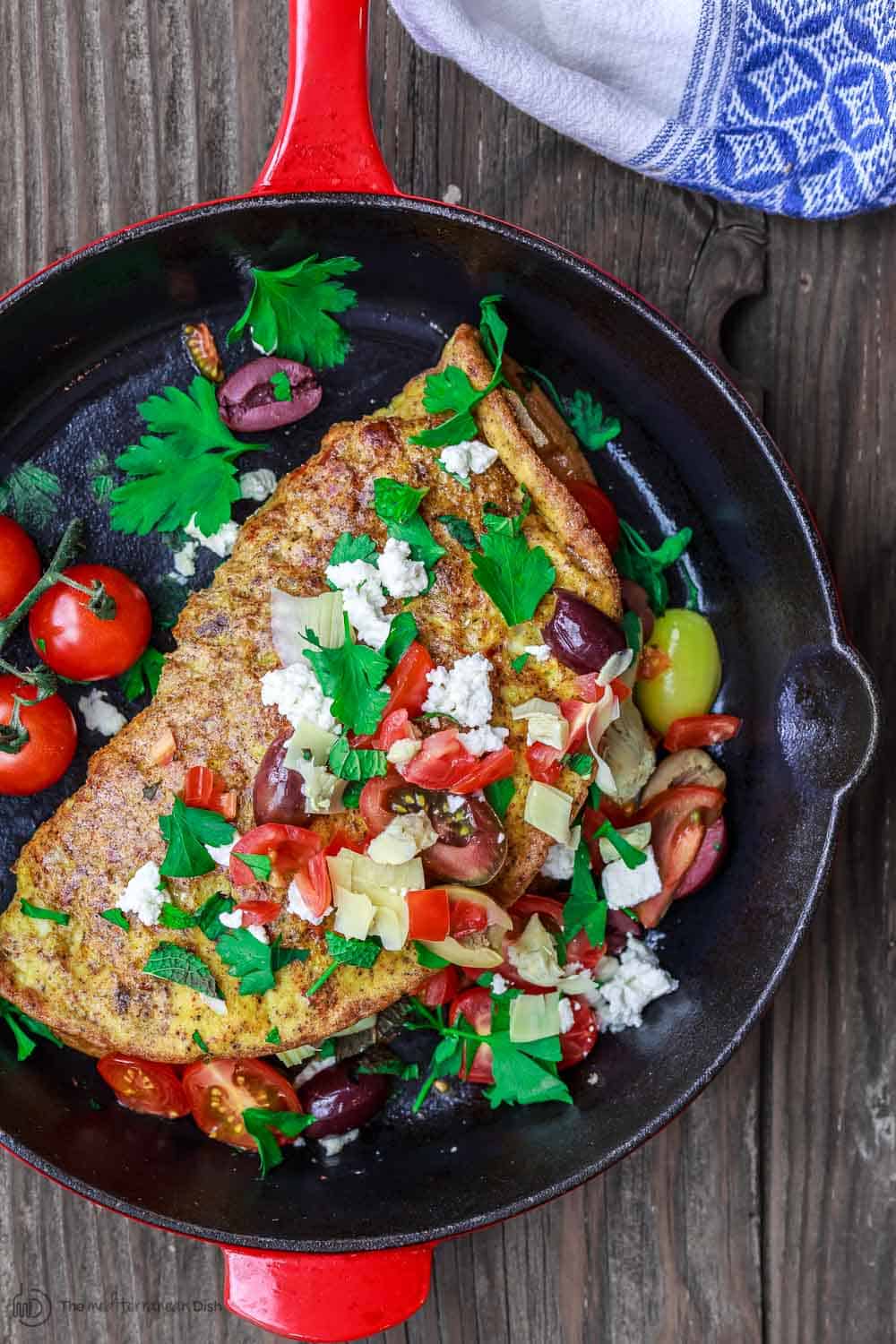 Mixed vegetables, olives and feta cheese garnish this egg omelette