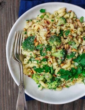 Simple, hearty Mediterranean bean and broccoli pasta. Tossed in olive oil, fresh parsley and favorite spices. A sprinkle of grated Parmesan and some toasted pine nuts seal the deal! See it on TheMediterraneanDish.com #pasta #pastadinner #mediterraneandiet #healthyrecipes #comfortfood #onepotpasta #onepot