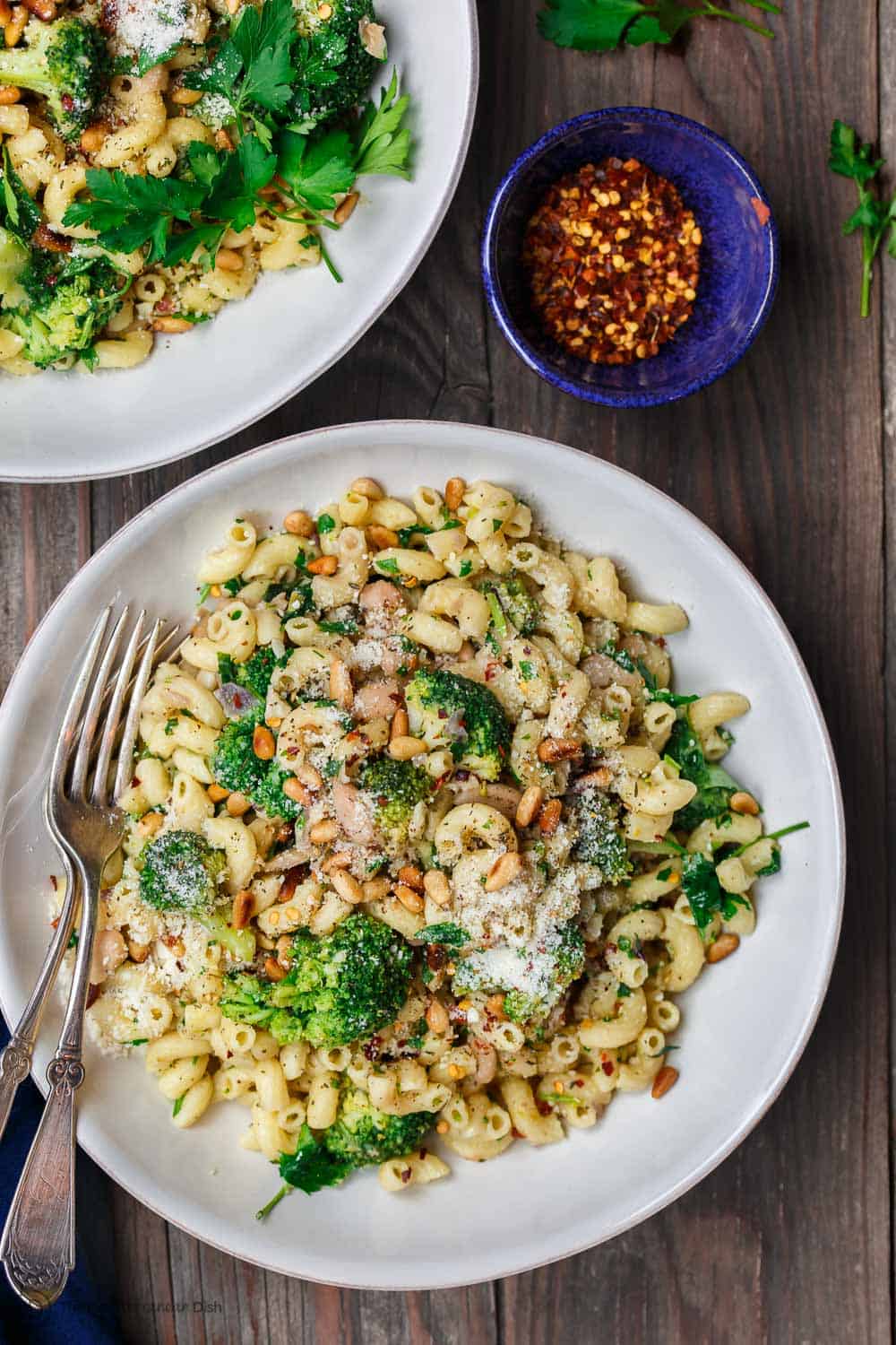 bean and broccoli pasta garnished with parsley and parmesan cheese