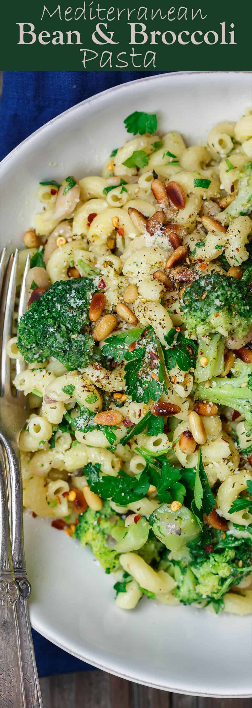 Mediterranean Bean and Broccoli Pasta | The Mediterranean Dish. Simple, hearty Mediterranean bean and broccoli pasta. Tossed in olive oil, fresh parsley and favorite spices. A sprinkle of grated Parmesan and some toasted pine nuts seal the deal! See it on TheMediterraneanDish.com #pasta #pastadinner #mediterraneandiet #healthyrecipes #comfortfood #onepotpasta #onepot