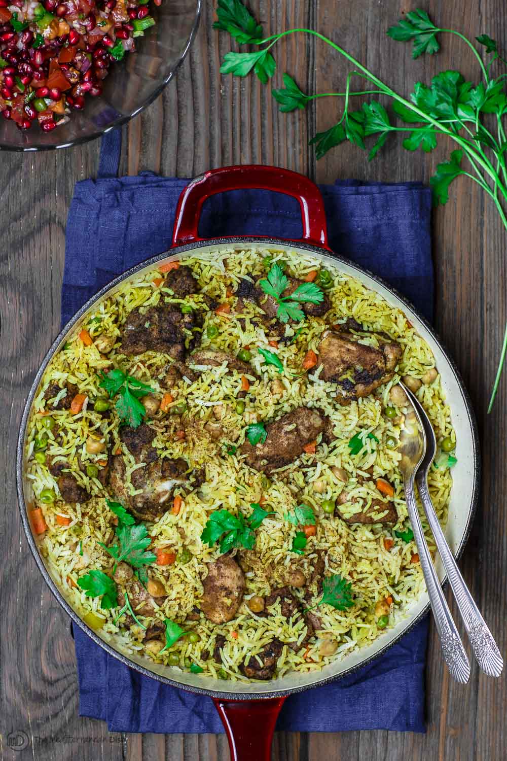 chicken and rice in a pan with serving spoon